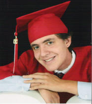 Matthew Valencia in red cap and gown for HS senior photo
