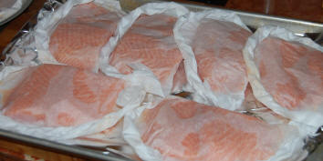 Salmon fillets in parchment packs ready for the oven