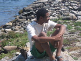 jon sitting on rocky beach in maine in 2008