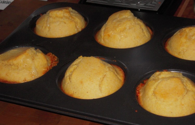 Corn muffins in the pan with cheddar cheese