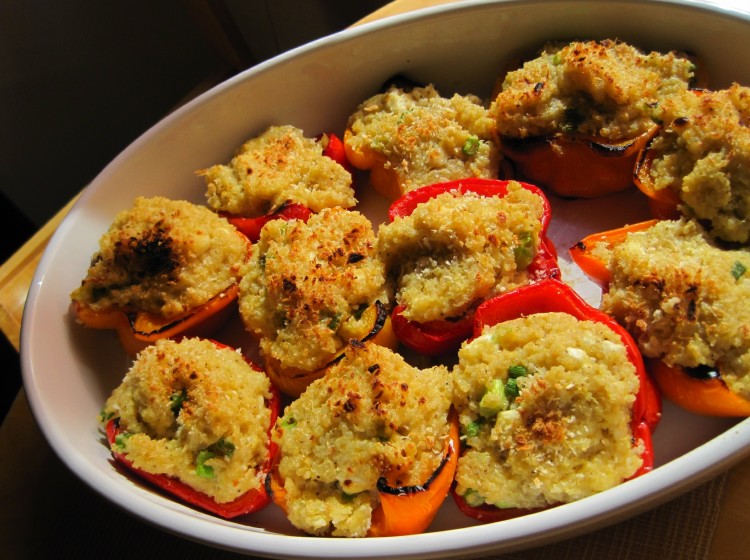 Peppers stuffed with quinoa stuffing in a white serving dish