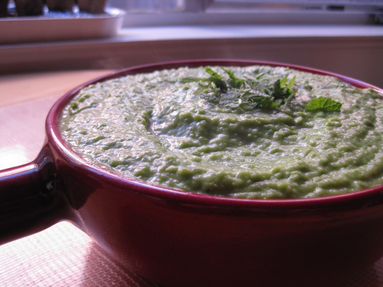 Mushy peas side dish in red earthenware saucepan