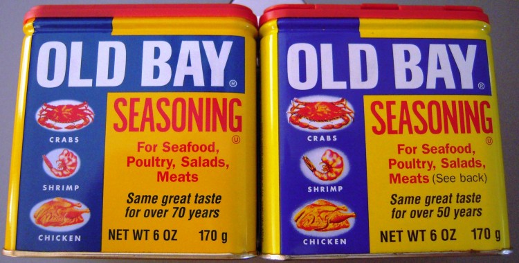 Two containers of old bay spice mix - one old and one new - side by side