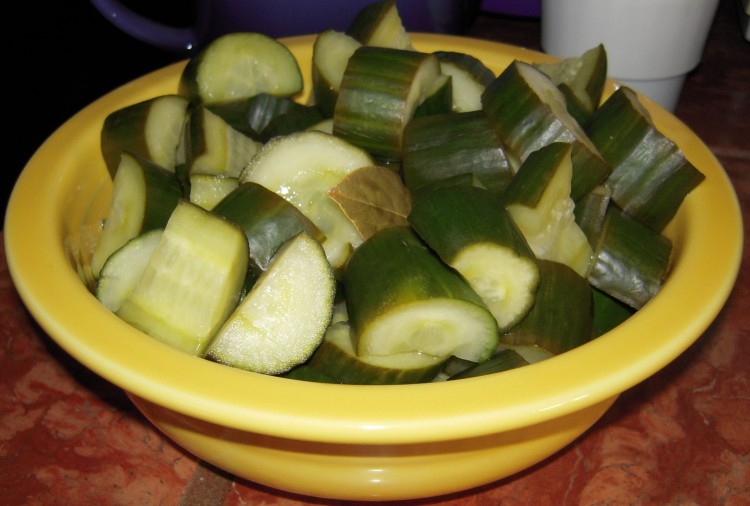 Yellow bowl of quick pickles made from English cukes