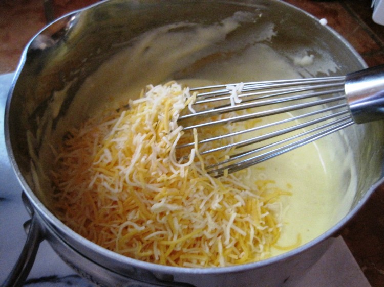 Sauce lightened with some whipped egg white and now adding the cheese