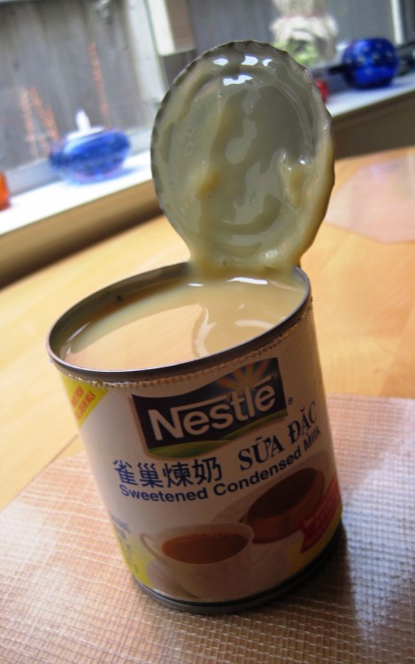 can of sweetened condensed milk with lid open